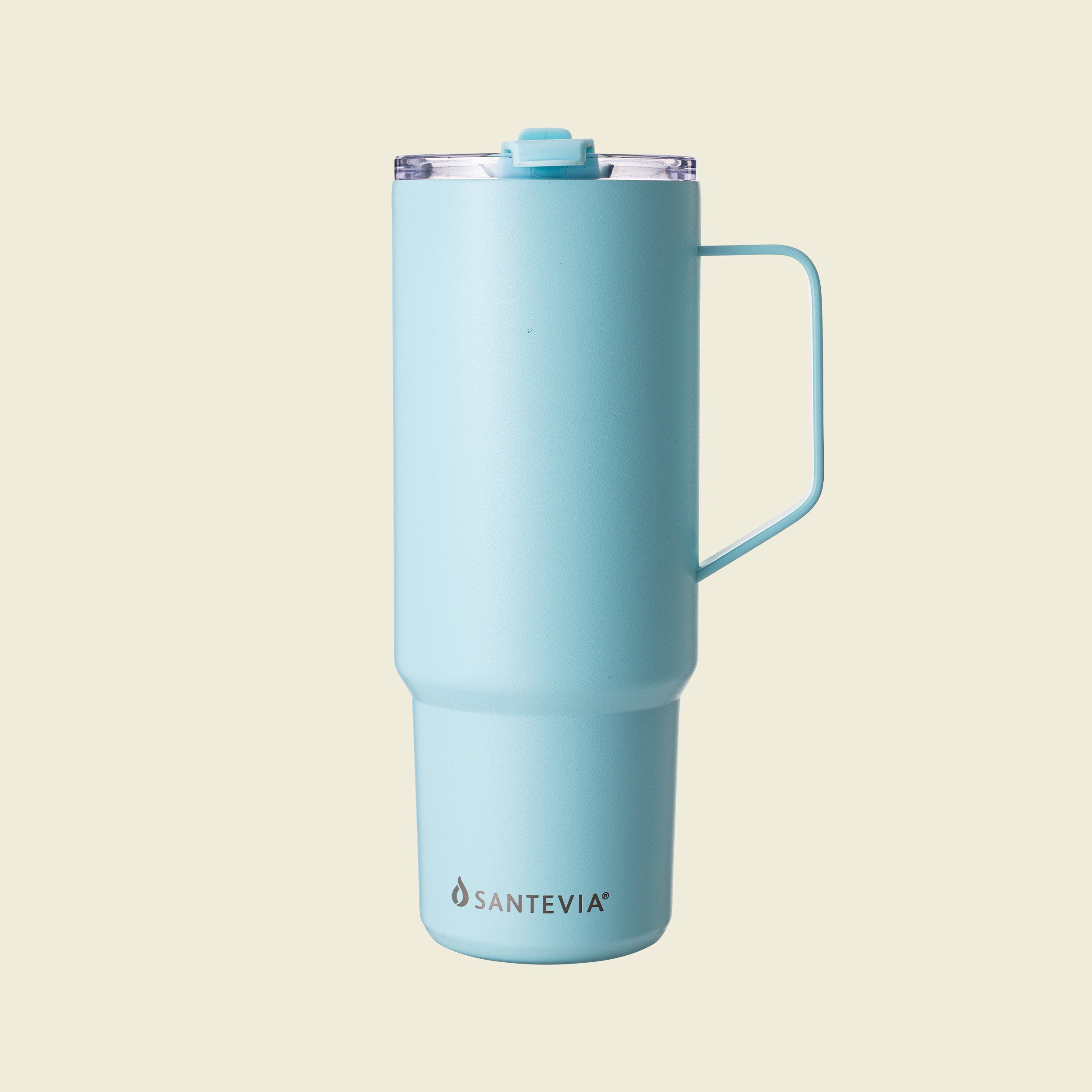 Light blue tumbler with handle on a beige background