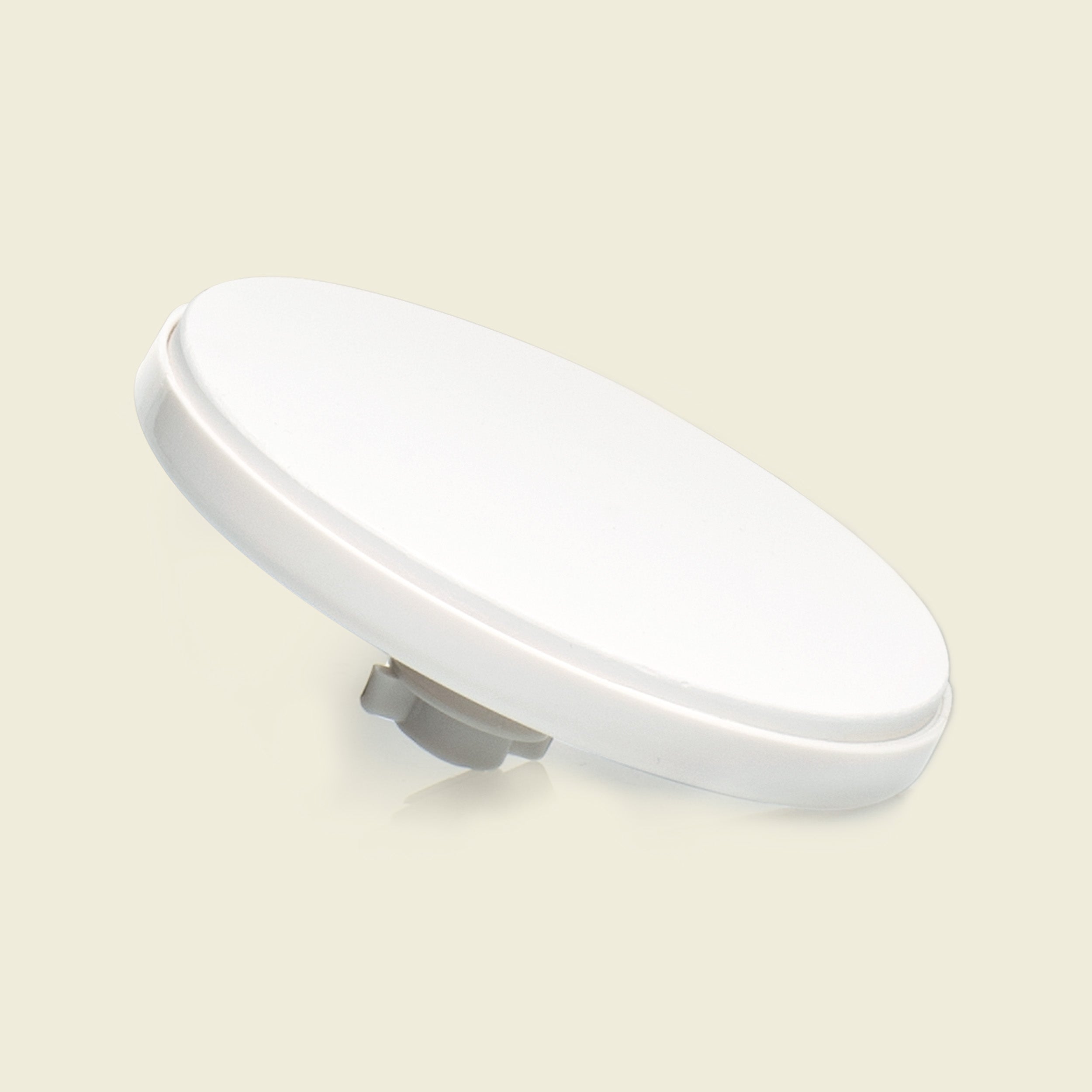 White oval light fixture on a beige background