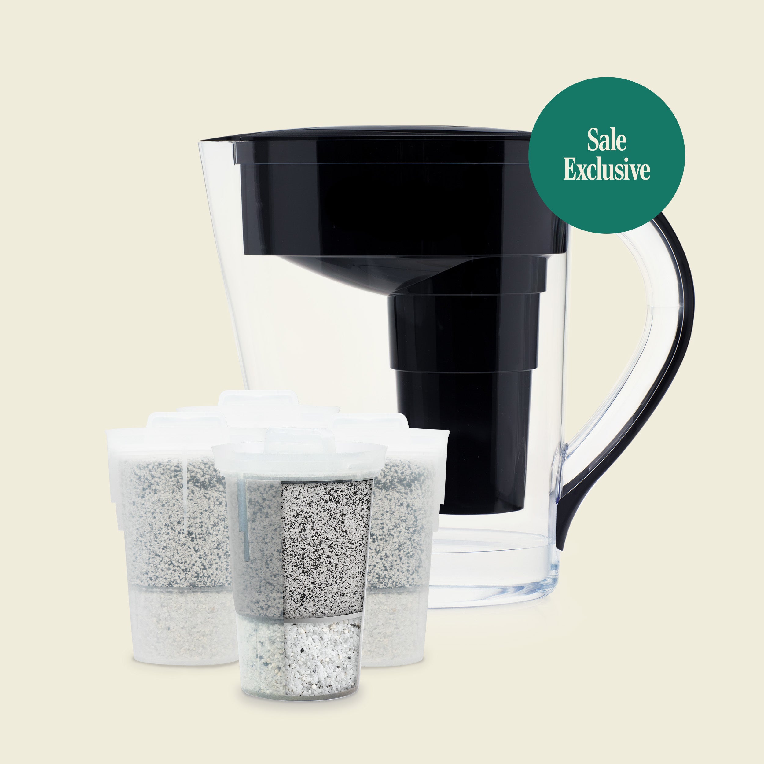 Clear water filter pitcher with black top and two filter cartridges on a beige background.