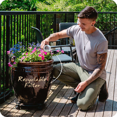Person dumping their recycleable MINA Fluoride Filter into a pot outside#filtration-type_fluoride-removal