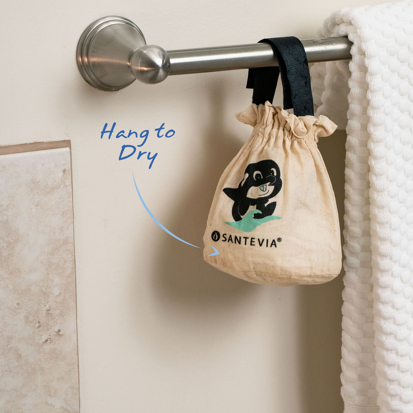 A Santevia Bath Filter hanging to dry on a bathroom towel rack.