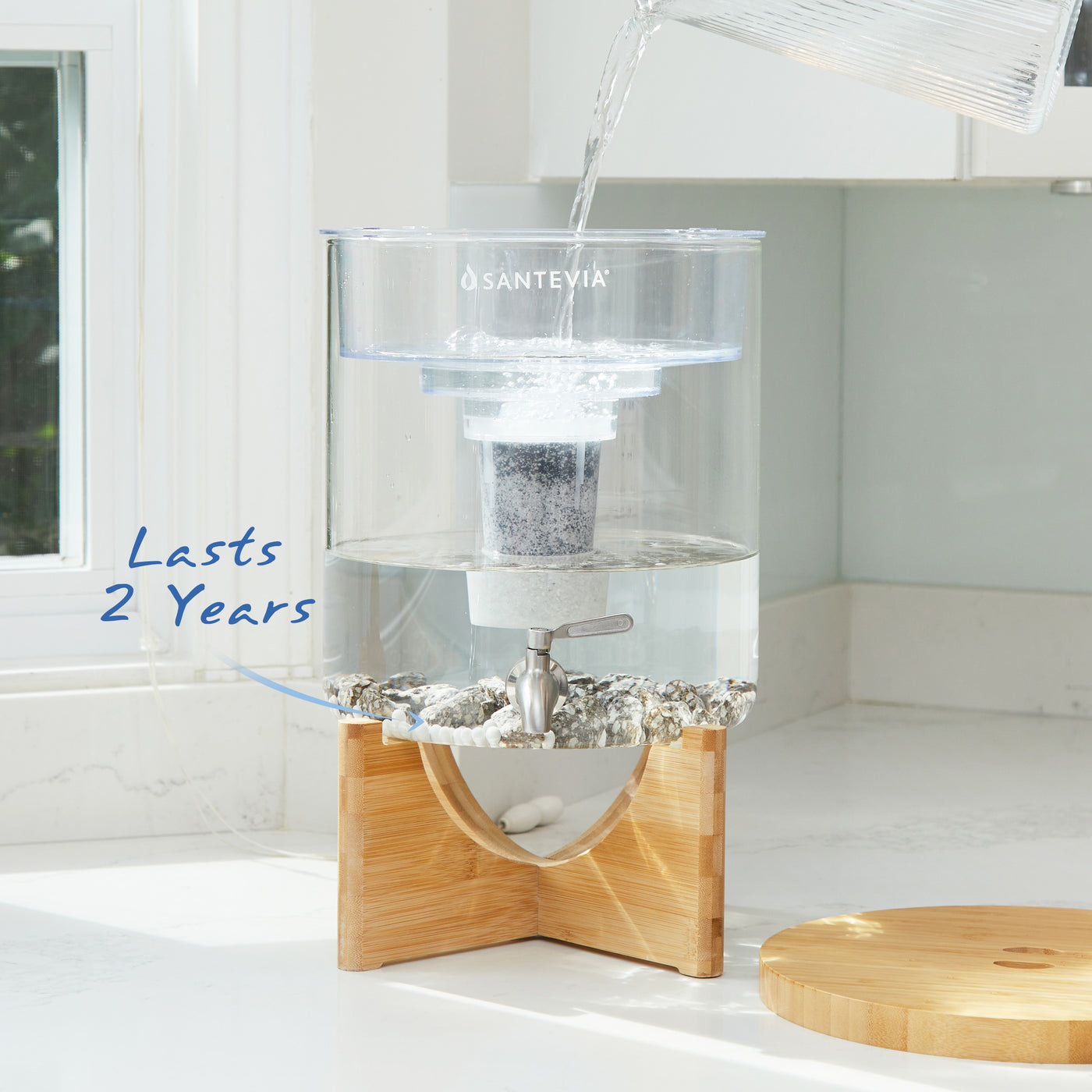 Santevia Glass Water System in a bright white sunny kitchen. Santevia Mineral Stones last for 2 years