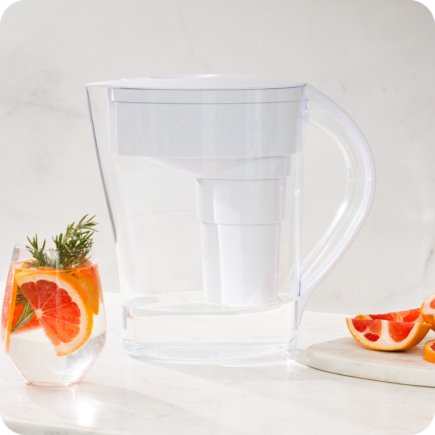 The Santevia MINA Alkaline Pitcher with a grapefruit and rosemary infusion drink#colour_white