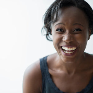 A woman laughing with a wide smile