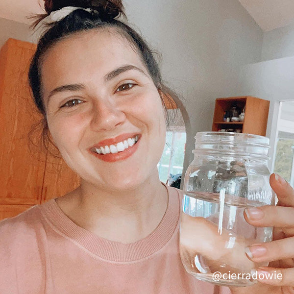 @cierradowie holding a glass of Santevia Alkaline Mineral Water and smiling