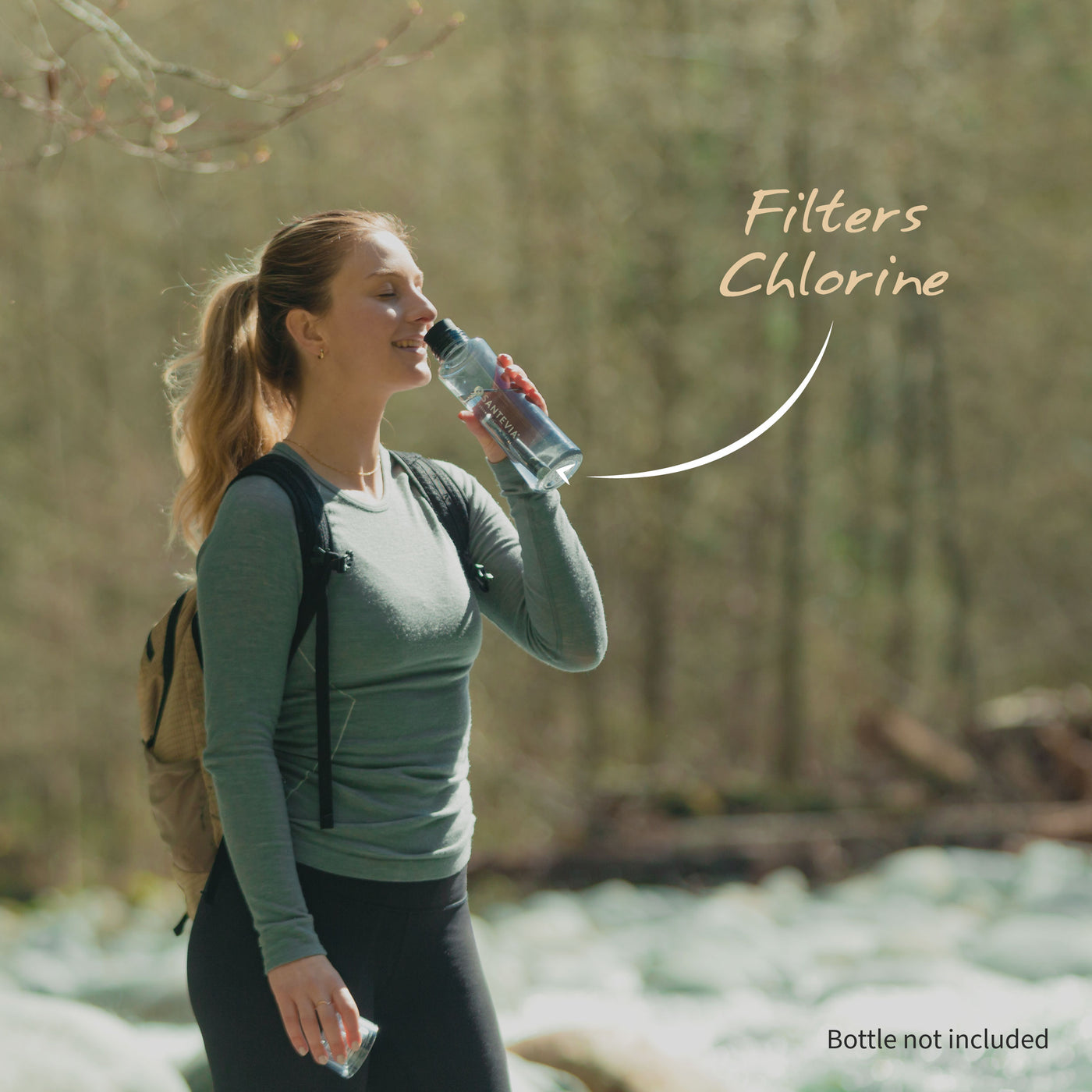 A woman hiking with the Santevia Water Bottle Filter and the Santevia Black Tritan Water Bottle
